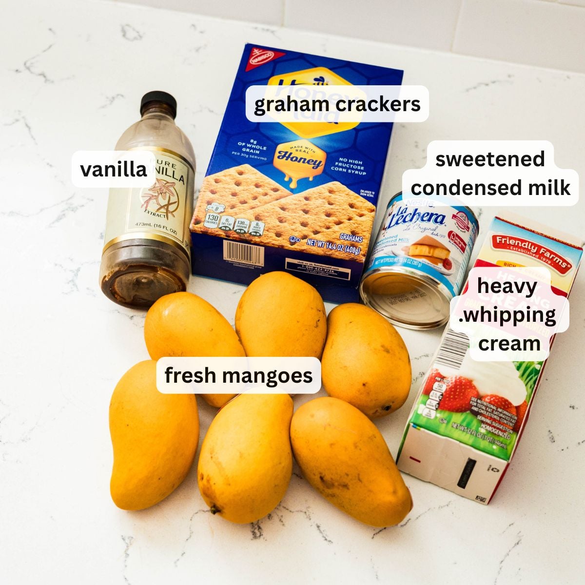 Ingredients for making Filipino mango float with graham crackers and mangoes