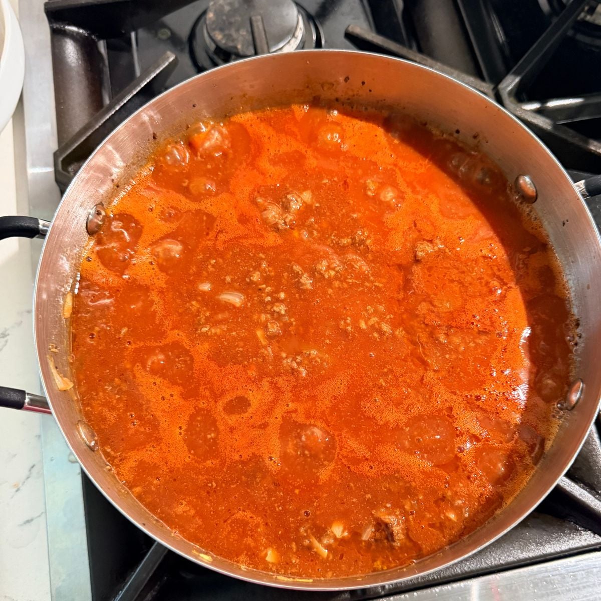 Homemade Filipino spaghetti sauce simmering in a pot