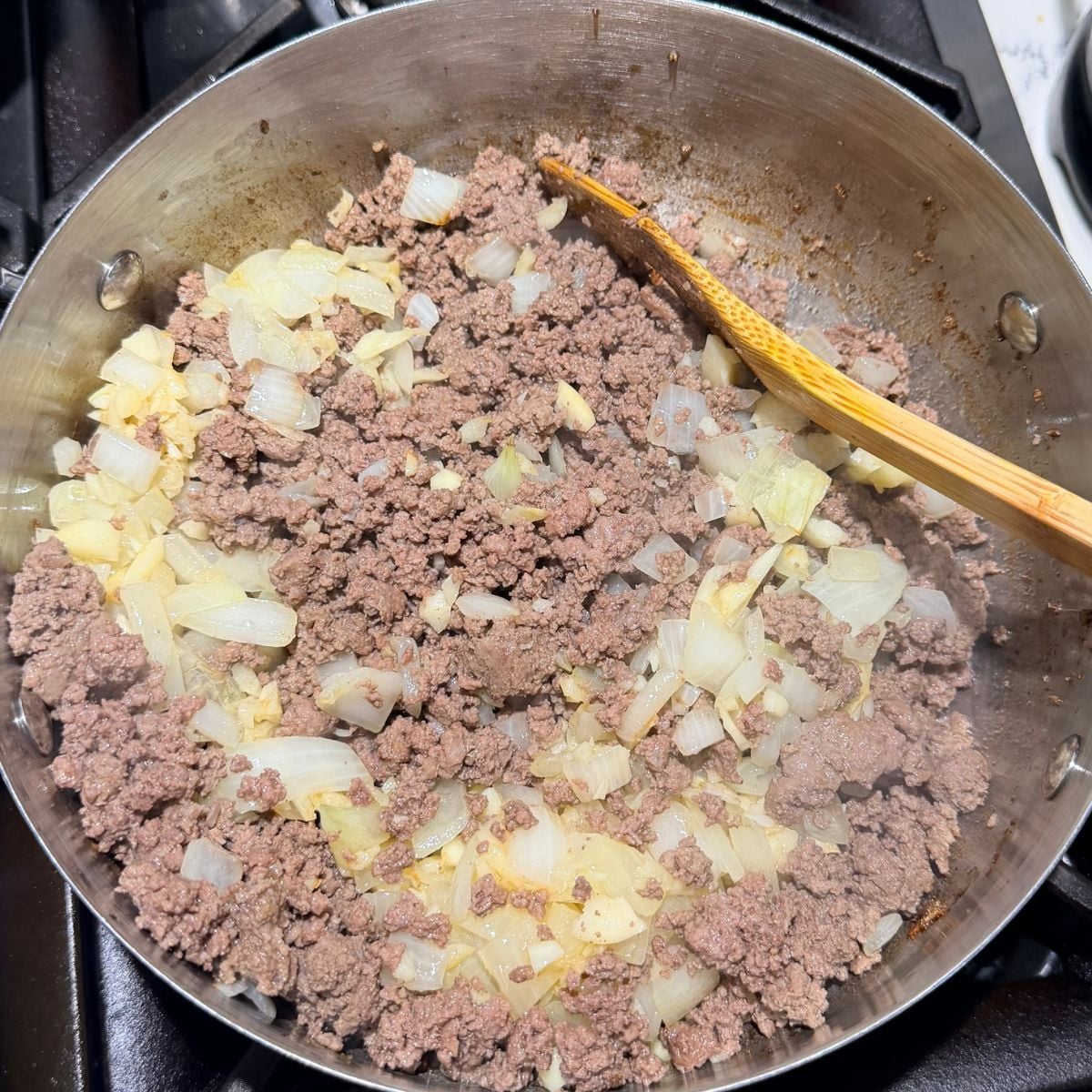Ground beef cooking with garlic and onion for Filipino spaghetti sauce