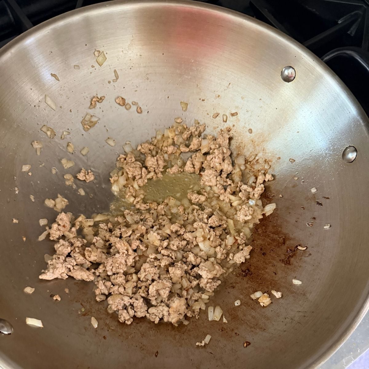 Cooking ground pork for lumpiang gulay filling