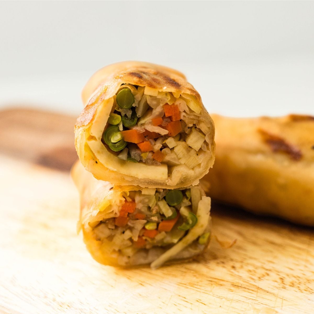 Crispy lumpiang gulay cut open to show the vegetable filling