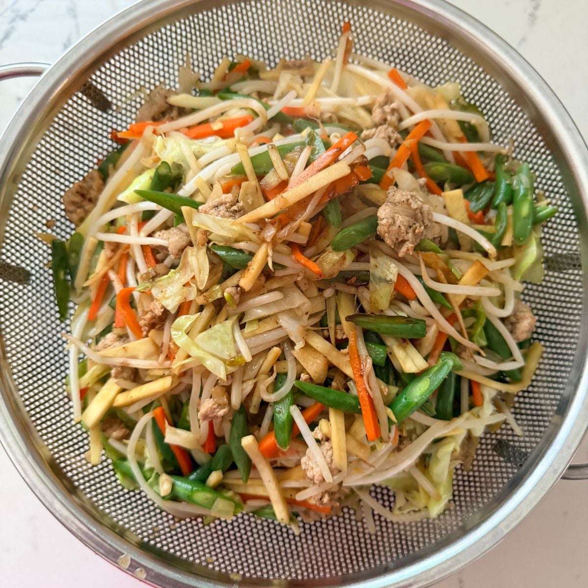 Draining lumpiang gulay filling before wrapping