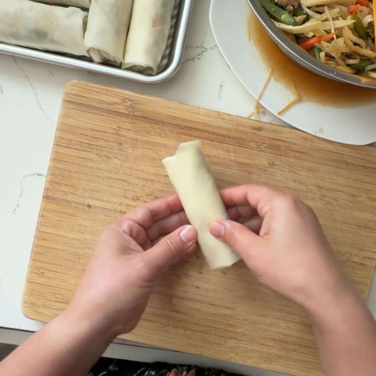 Freshly wrapped lumpiang gulay held before cooking