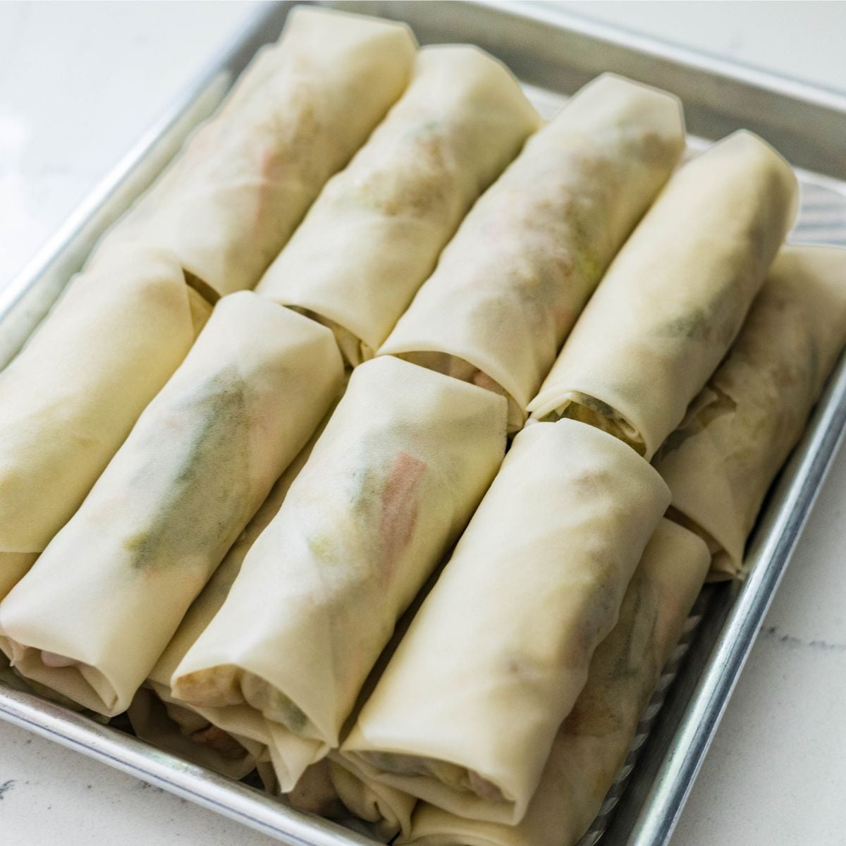 Freshly wrapped lumpiang gulay arranged on a tray