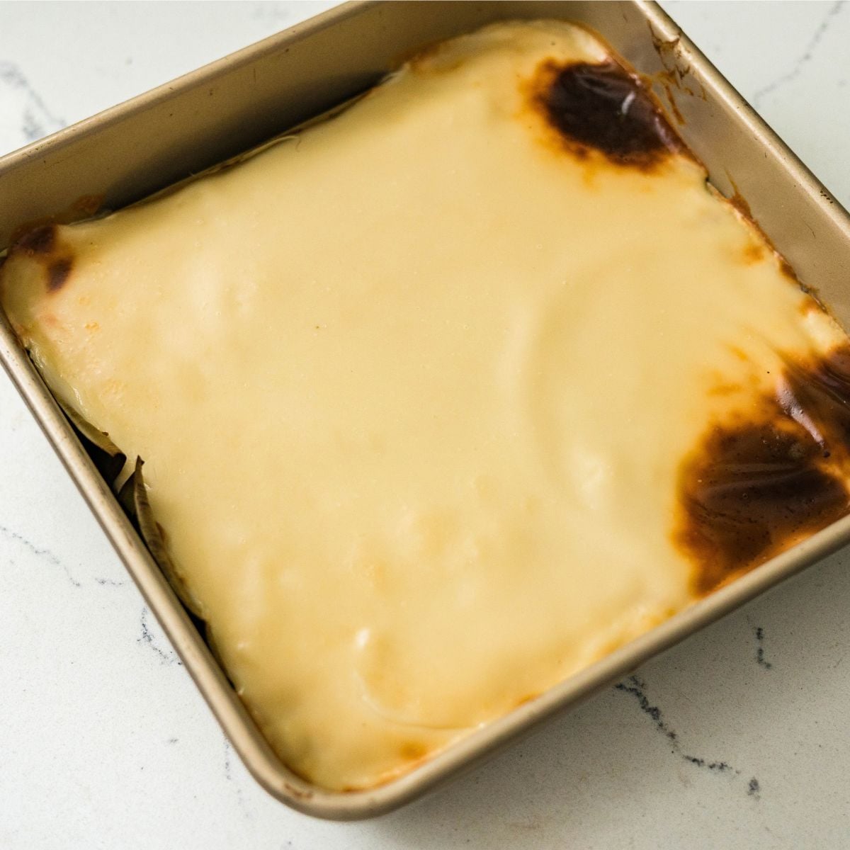 Broiled inutak with a golden, blistered coconut topping.