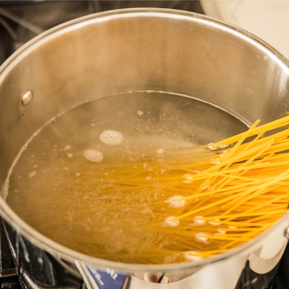 Spaghetti cooking in boiling water for carbonara