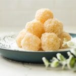 Filipino macapuno balls coated in desiccated coconut and served on a plate
