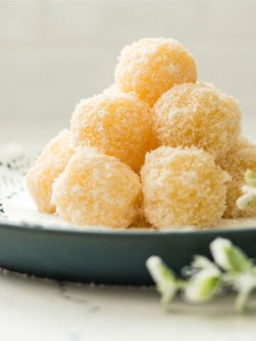 Filipino macapuno balls coated in desiccated coconut and served on a plate