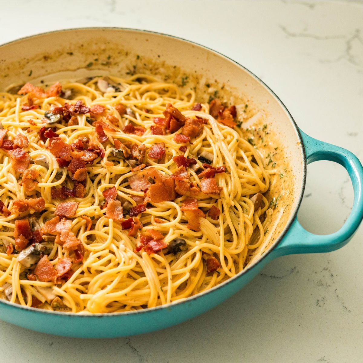 Filipino-style carbonara with creamy sauce, bacon, mushrooms, and spaghetti