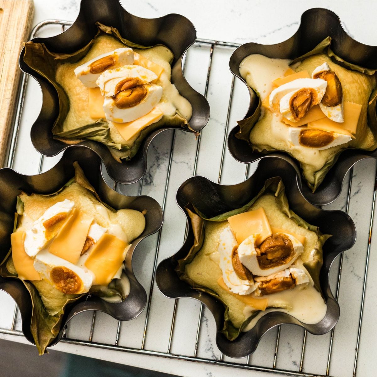 Fresh baked bibingka in banana leaf lined molds
