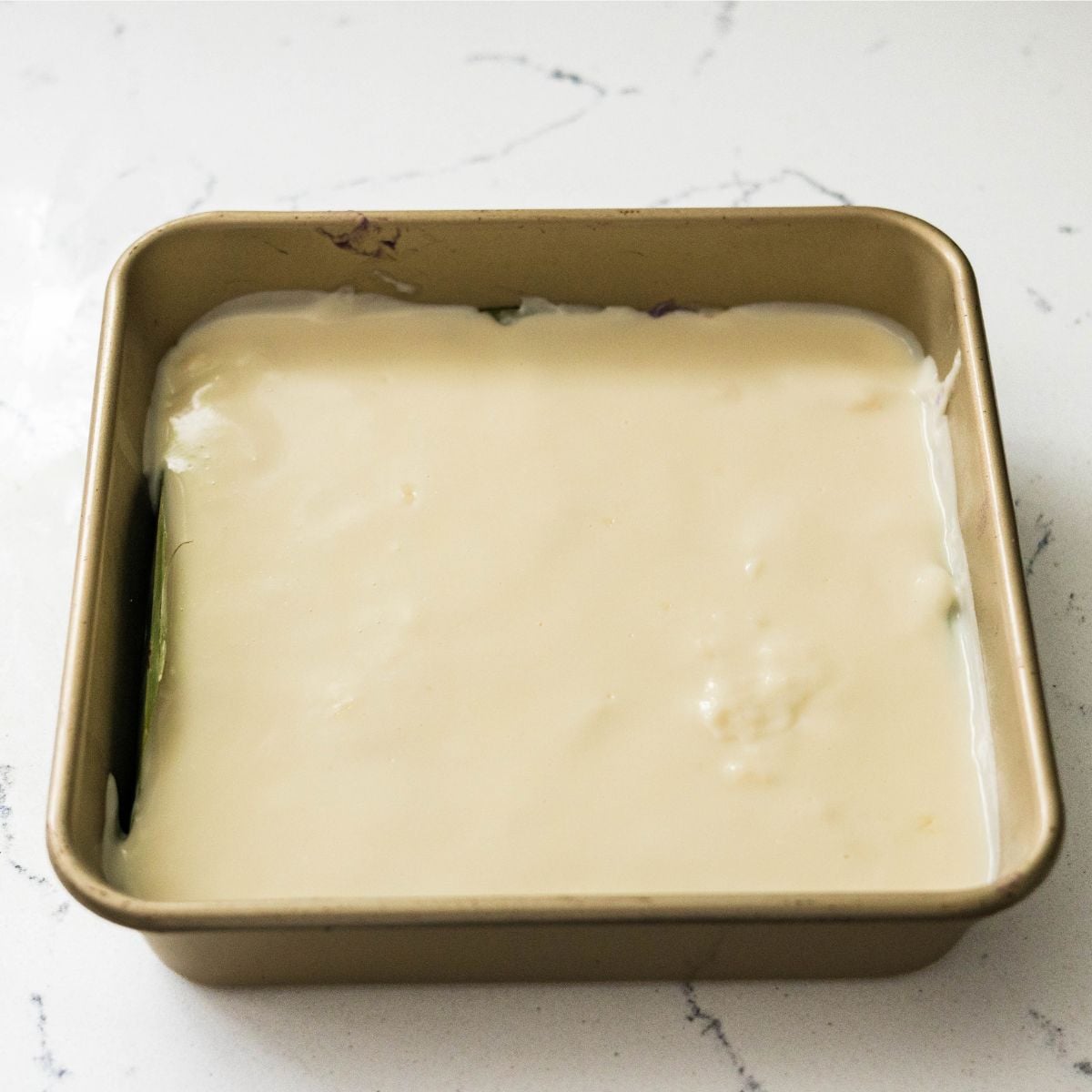 Inutak topped with creamy coconut milk mixture before broiling