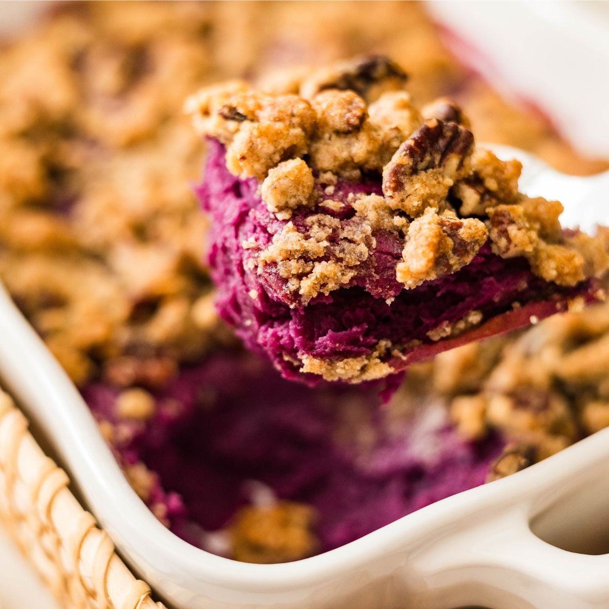 Close up of purple sweet potato casserole with pecan streusel