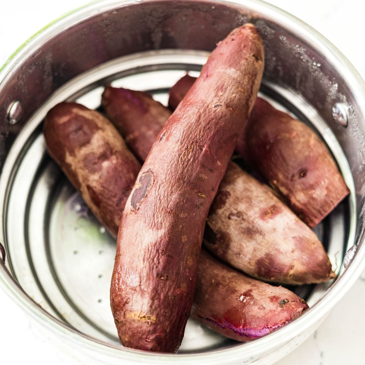 Whole purple sweet potatoes ready for cooking